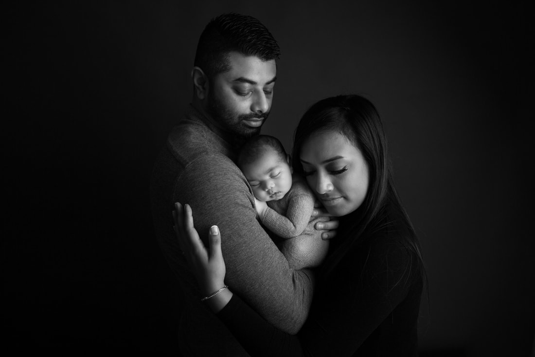 Black and white family cuddles baby cuddles newborn snuggles Clare Long photography Kent newborn photographer