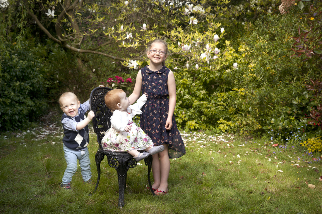 Family photographer London Clare Long Photography cousins magnolia tree