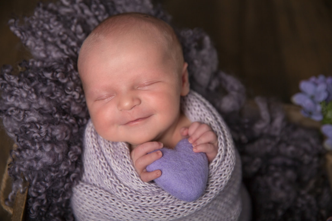 Clare Long Photography Picture Newborn baby purple heart baby smiles wind
