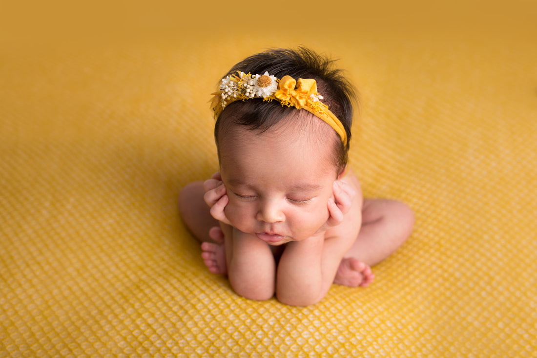 Baby girl sleeping in newborn photography pose on mustard composite image for baby safety