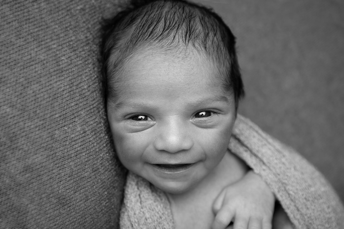 Clare Long photography Kent newborn photographer black and white Picture awake smile big grin